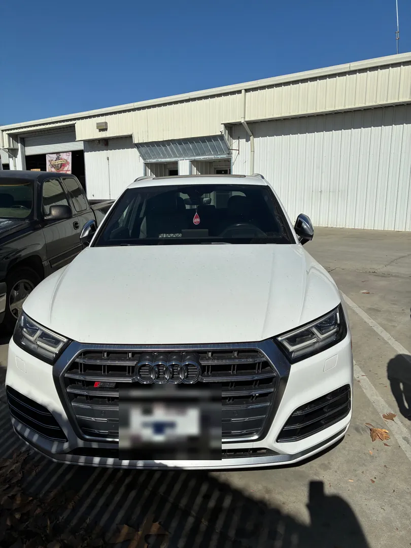 Front view of a white Audi SQ5 parked outside a repair shop - Winchester, CA