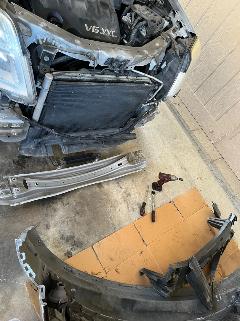 Bumper cover removed exposing the core support and condenser on a sedan - Perris, CA