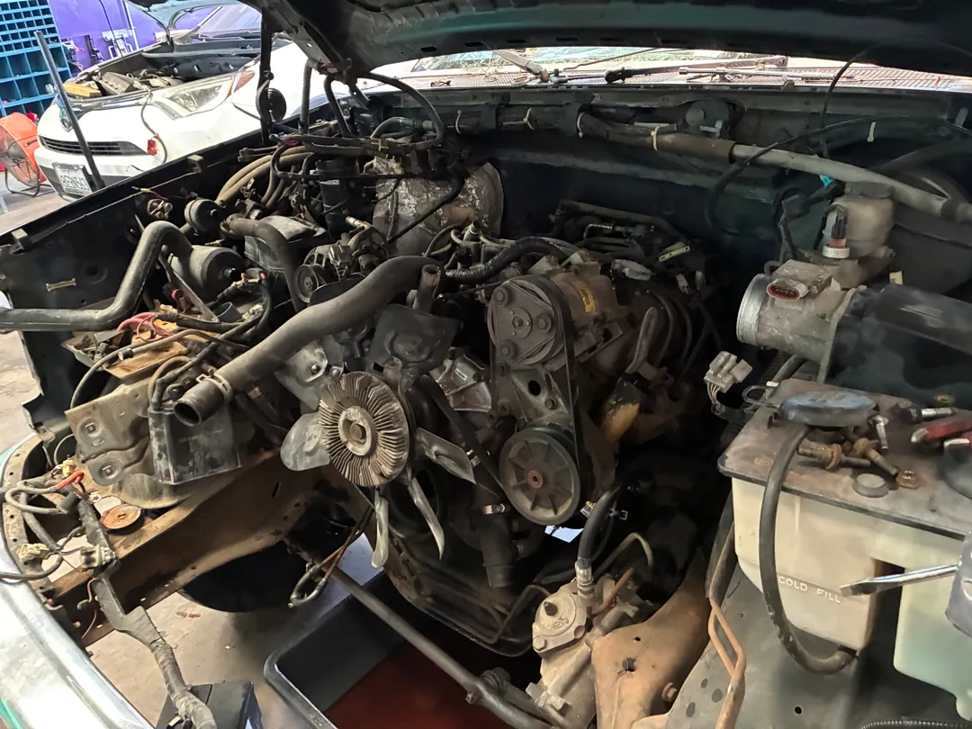 Engine bay of an 80s Ford pickup with accessories and hoses removed - Lake Elsinore, CA