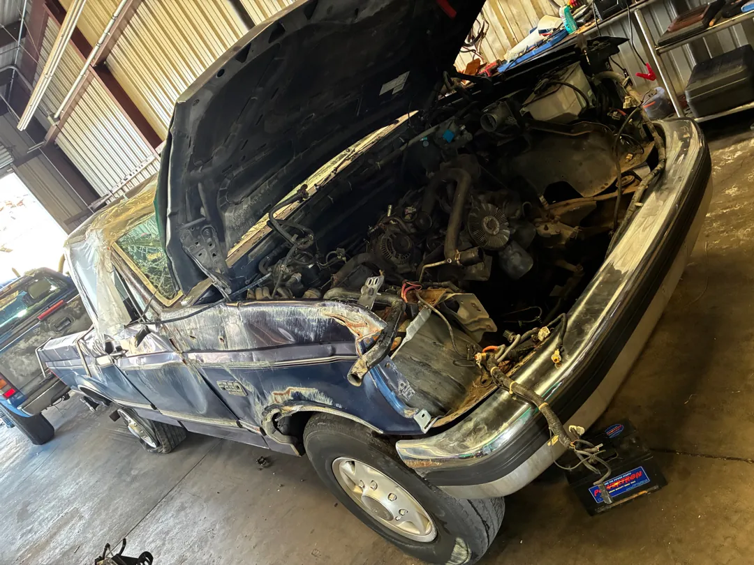 Hood up and front end apart on a classic Ford pickup under a carport during an engine swap - Lake Elsinore, CA