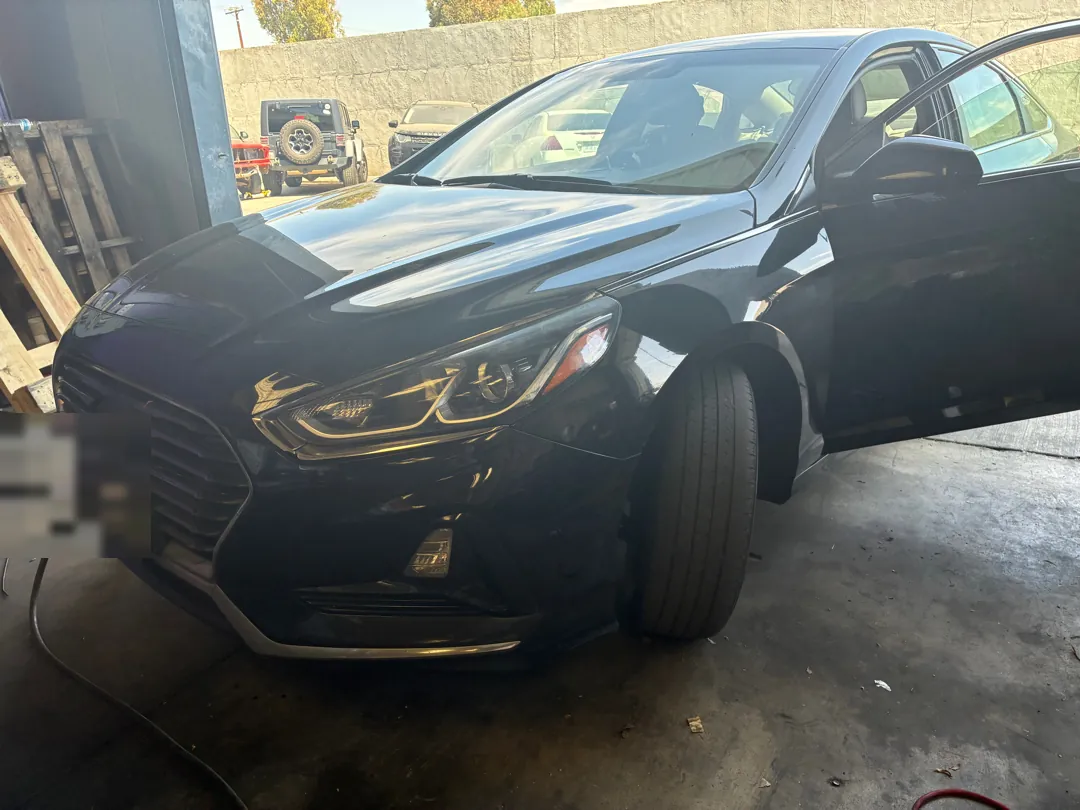 Hyundai Sonata with the hood open and front bumper cover removed during a repair - Murrieta, CA