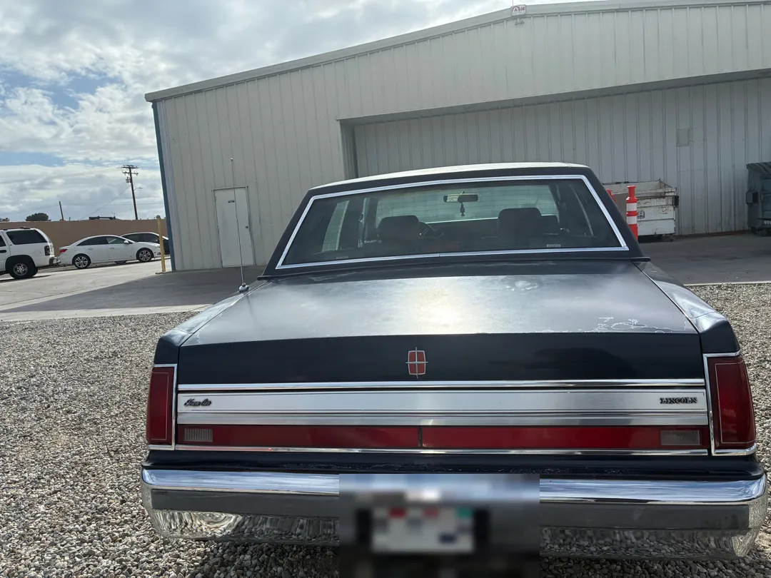 Rear view of a black and red 1988 Lincoln Town Car - Perris, CA