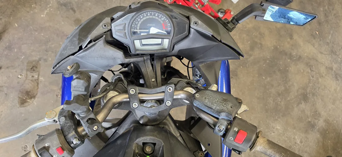 Front cockpit of a Kawasaki sport bike with fairings off, showing clip-ons, master cylinders and gauge cluster - Murrieta, CA