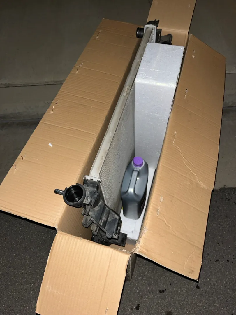 Brand new replacement radiator still in its shipping box on a driveway - Menifee, CA