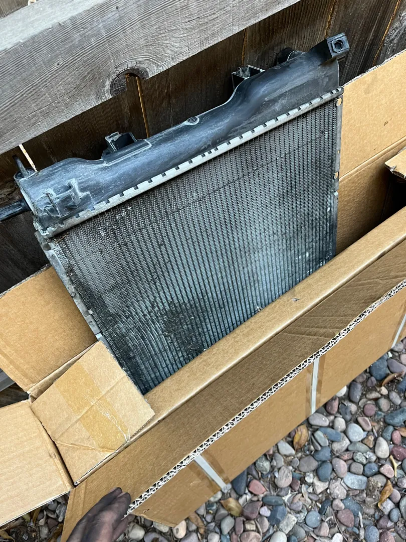 New replacement radiator sitting in its box before installation - Perris, CA